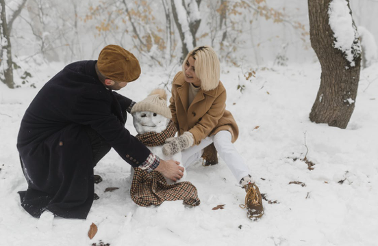 Couple building a snowman