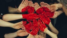 many hands together with red heart - student mental health