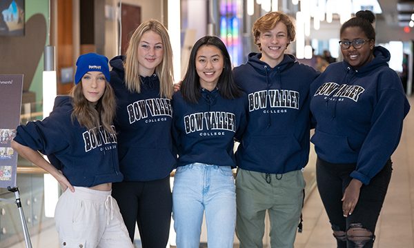 Bow Valley College students wearing branded, hooded sweatshirts.