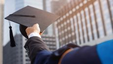 A student holding a graduation cap