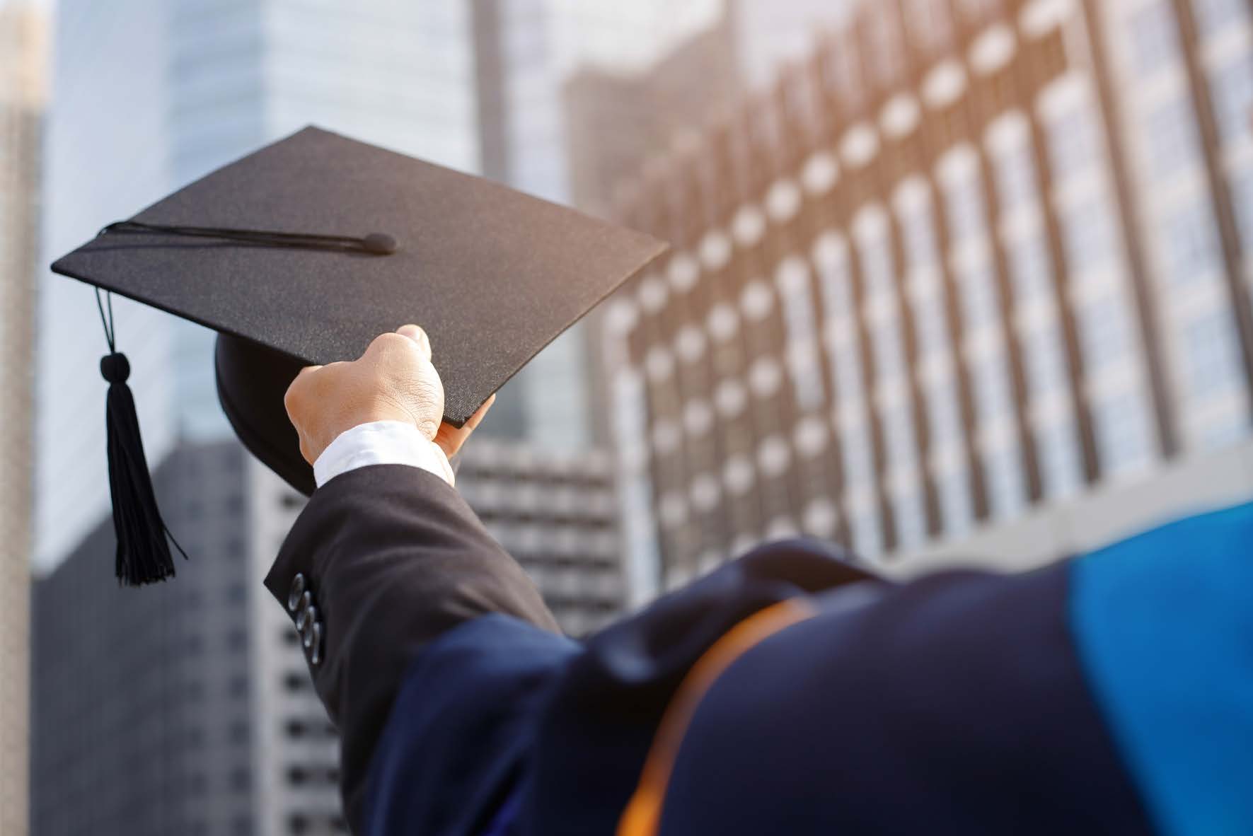 A student holding a graduation cap