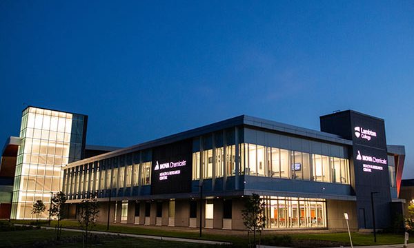 An exterior nighttime view of a Lambton College campus in Ontario, Canada. 