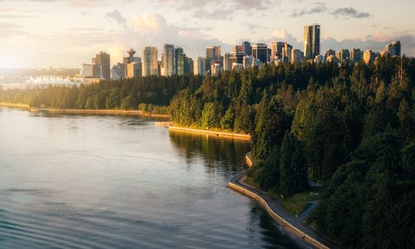 A view of the Stanley Park Seawall with the downtown Vancouver in the background.